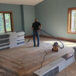 Clearing every speck of dust before the new flooring goes down.